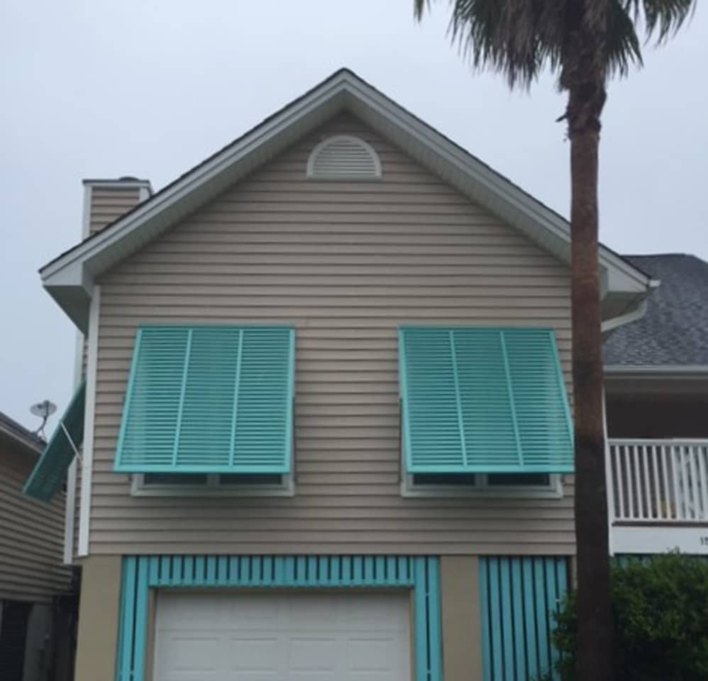 Second story windows with Bahama shutters