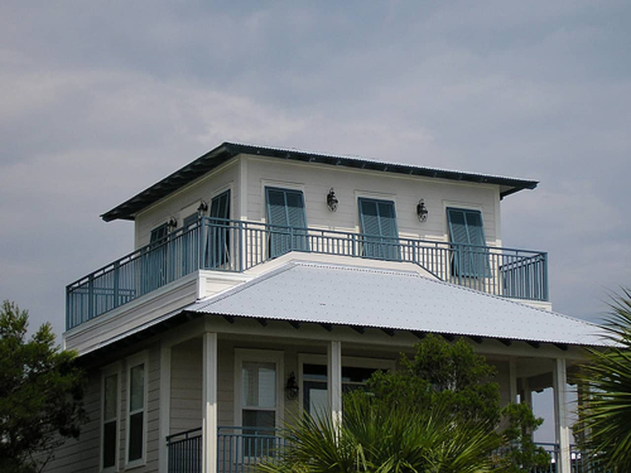 Bahama shutters on second floor of house