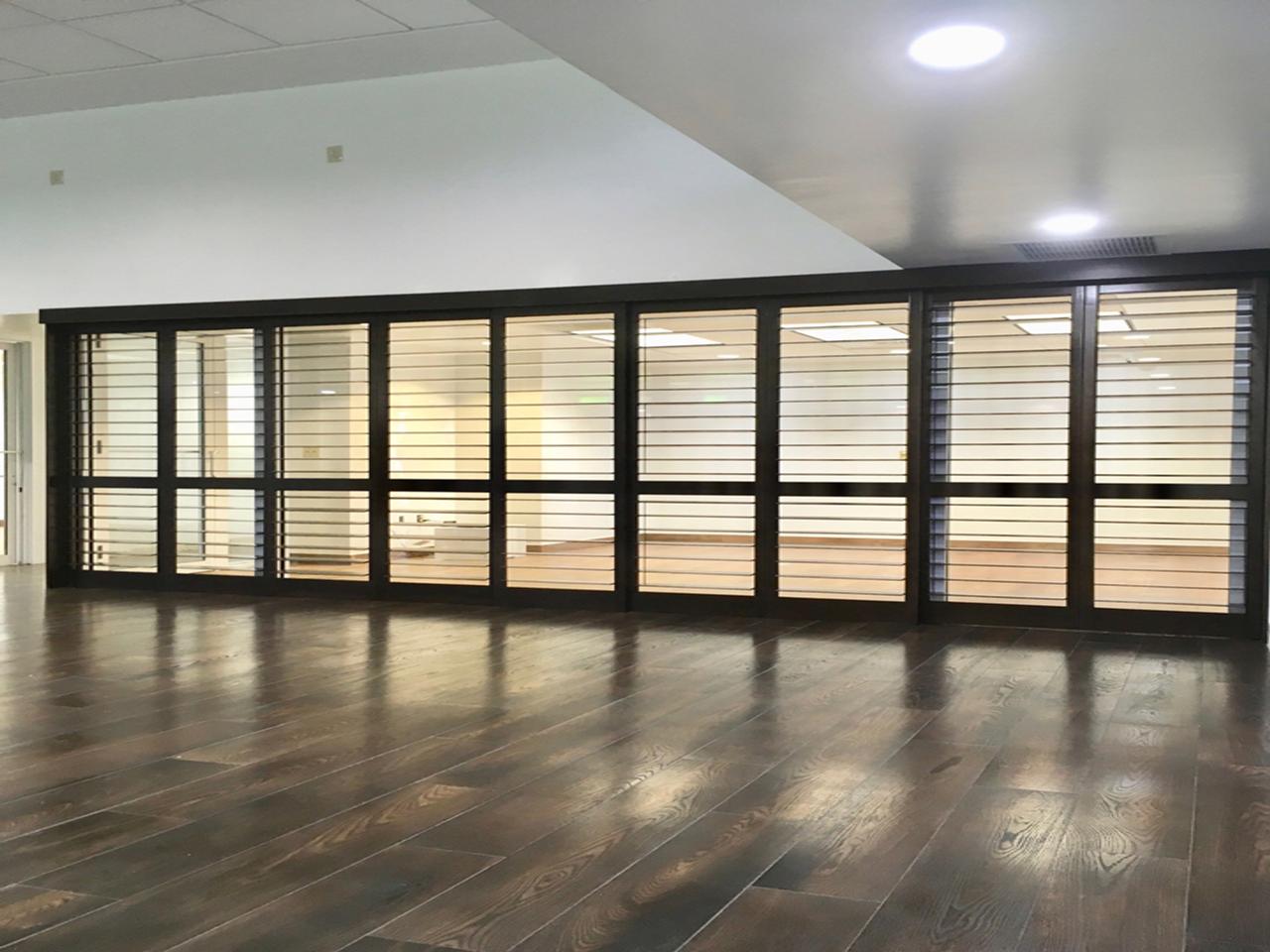 Room divided with plantation shutters with bypass doors
