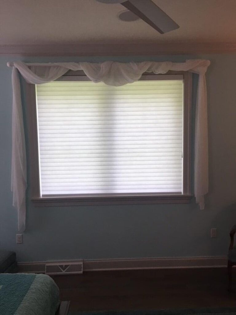 Energy efficient honeycomb shades in a bedroom