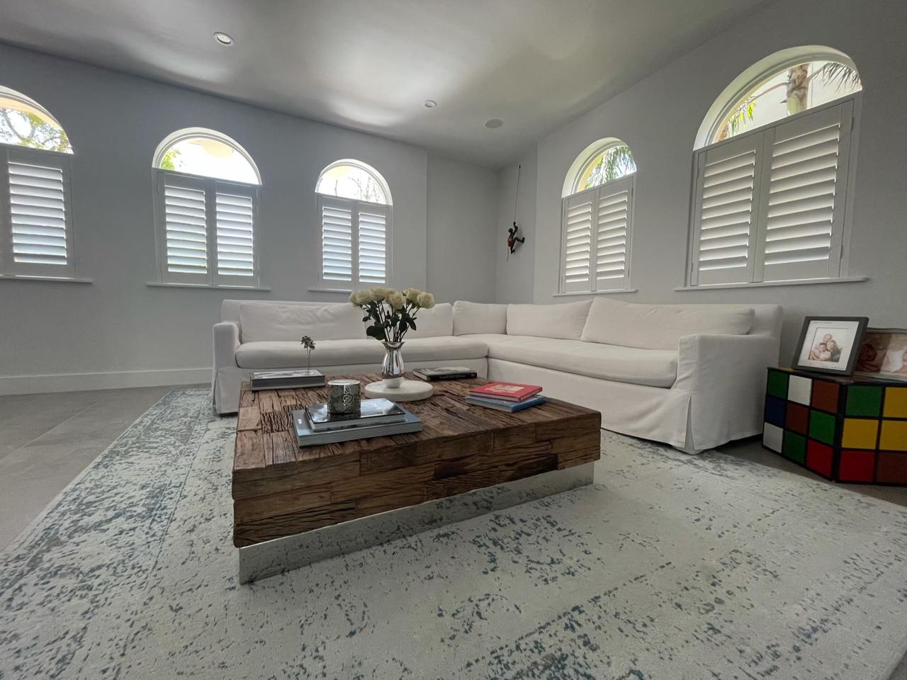 Arched windows with plantation shutters