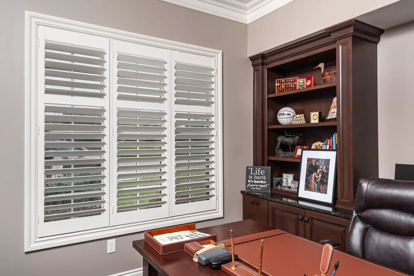 Heritage wood shutters in a home office