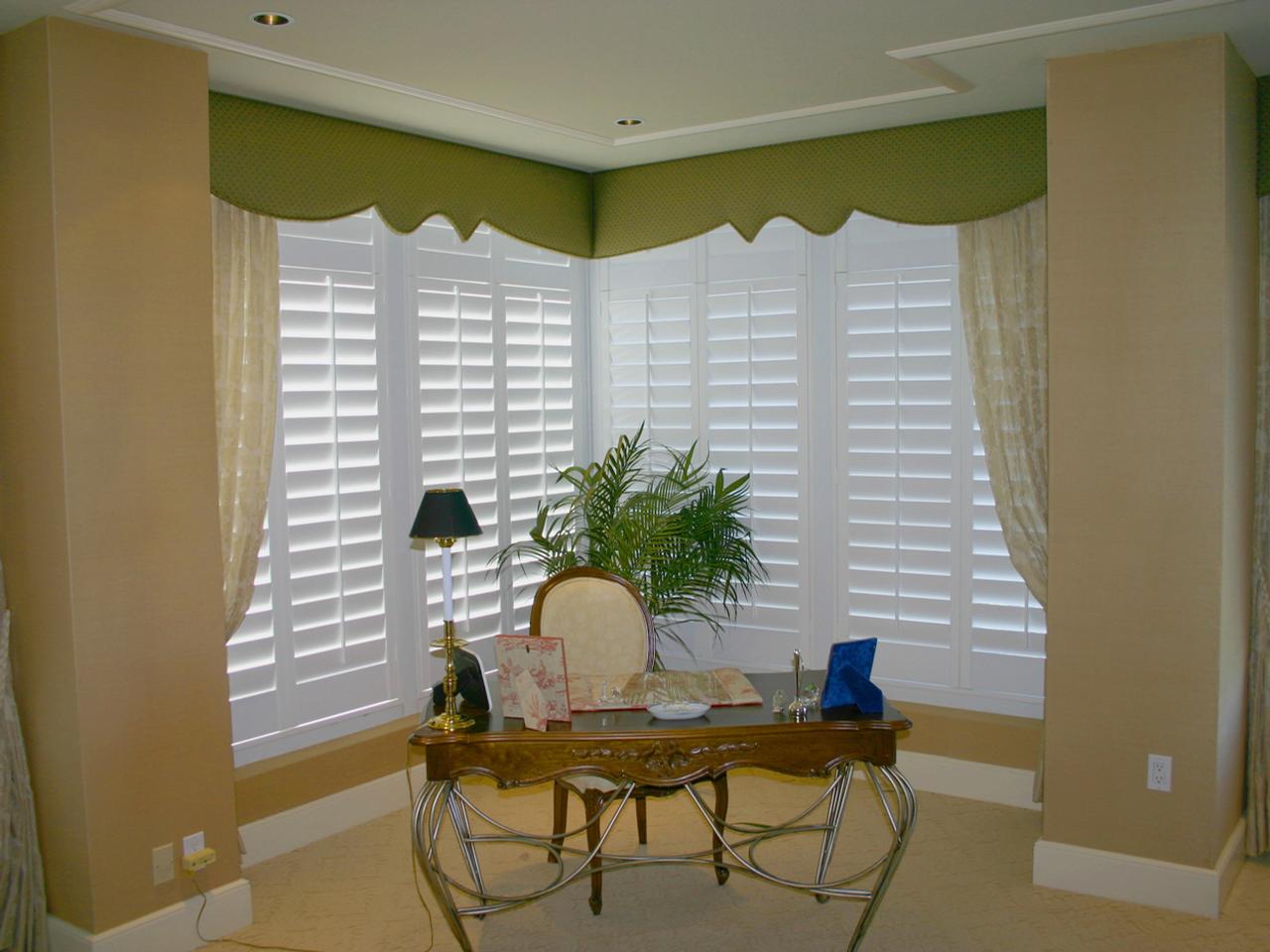 Home office with shutters on the corner windows