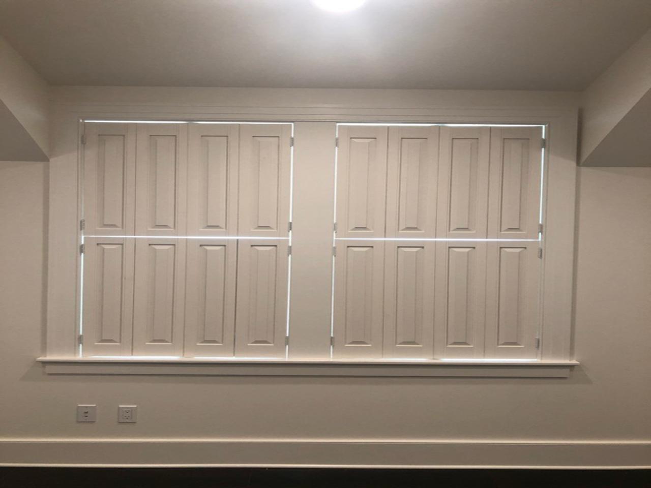 Raised panel shutters on a double window