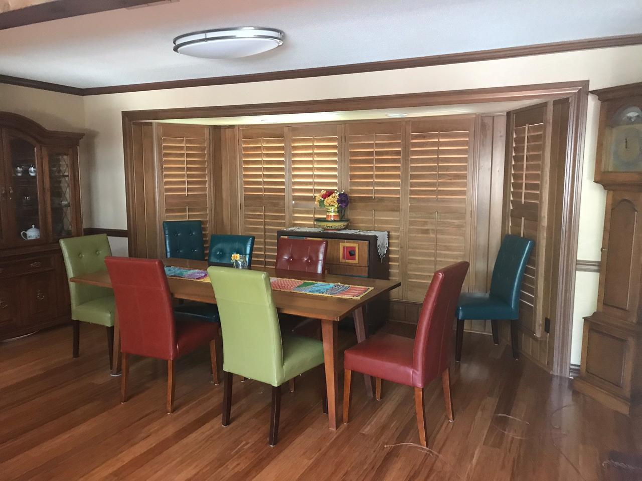 Dining room with stained shutters on the bay window